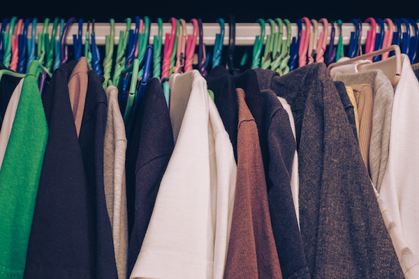 Closets stuffed with hung up clothing